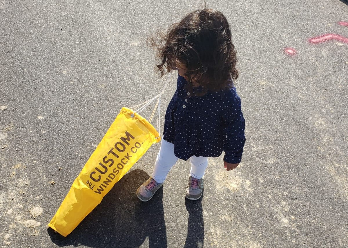 Child holding the Custom Windsock Company's custom windsock